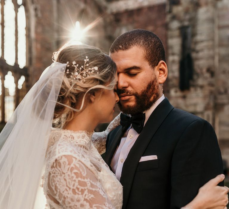 Bride with a classic updo, hair vine and wedding veil 