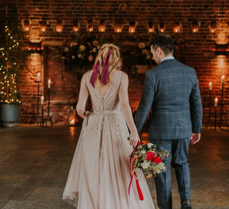 Bride in a pearl wedding dress with burgundy ribbon in her hair at Hazel Gap Barn wedding 