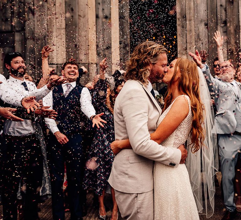 Beautiful confetti throwing portrait at barn wedding