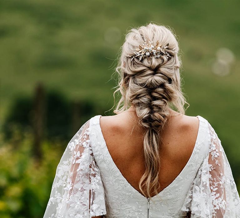 Bride in a lace wedding dress with cap sleeves with a braided hair and gold headdress