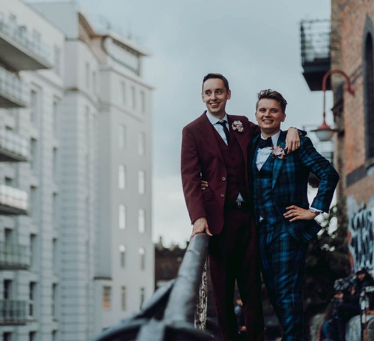 Grooms stand on balcony on their wedding day | Kim Williams Weddings