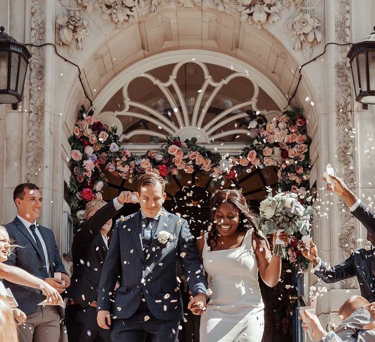 Black bride & groom leave wedding ceremony as confetti is thrown around them for airbnb wedding