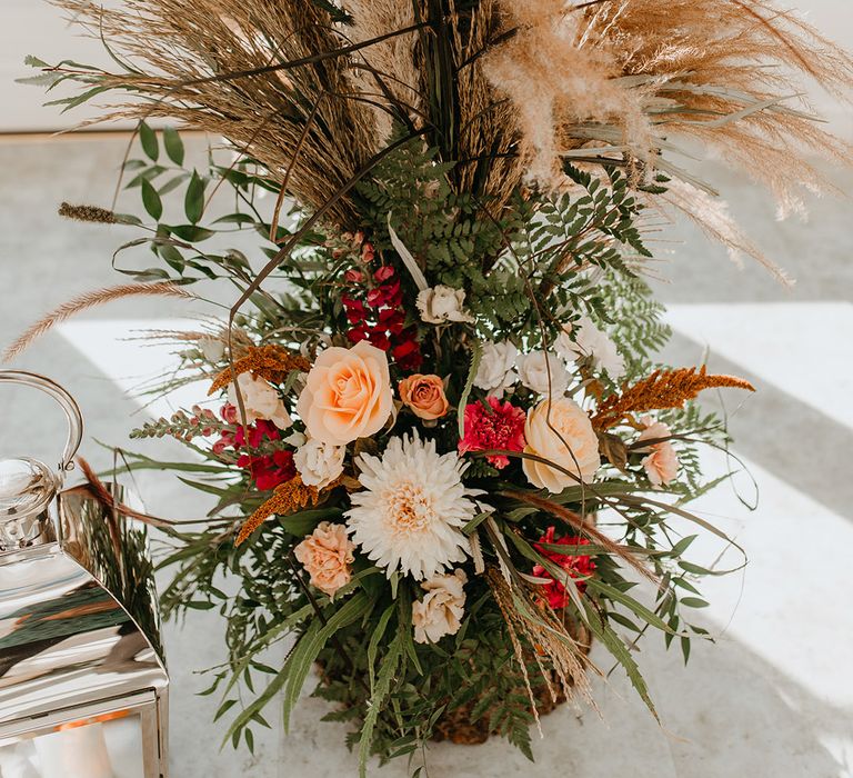 Autumnal floral bouquet complete with pampas grass and green foliage with pops of colour