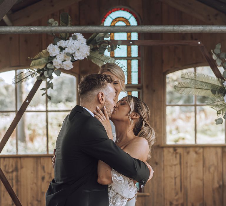 Groom kisses his bride on their wedding day