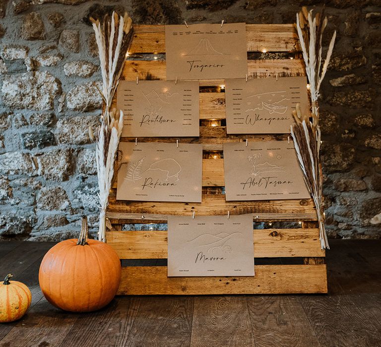 Wooden palette complete with pampas grass decor for table placements 