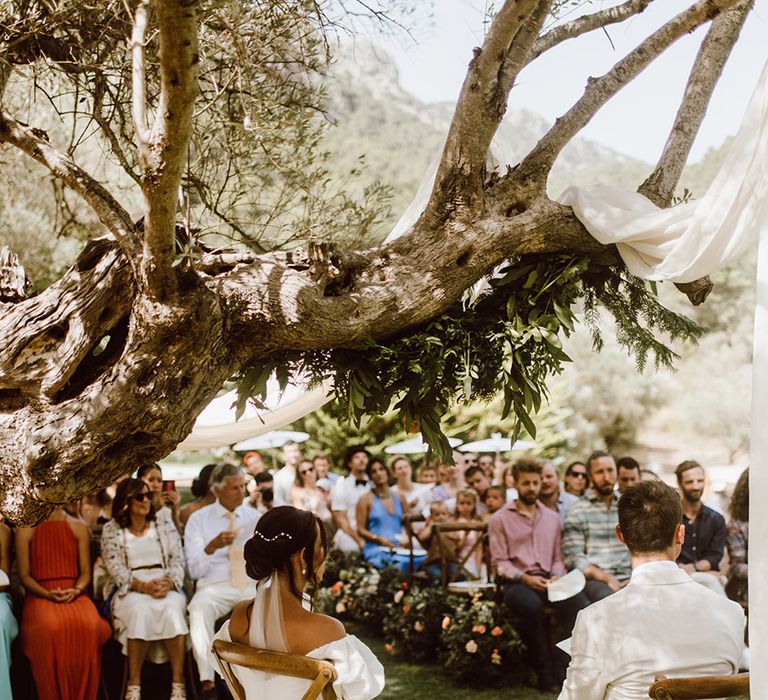 bride and groom seated at the end of the aisle