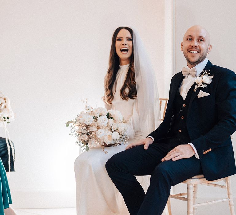 Iscoyd Park wedding ceremony with bride in a long sleeve wedding dress and groom in a black three-piece suit with monk shoes 