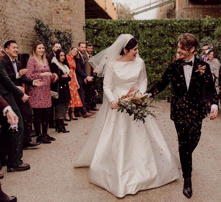 Bride and groom walk through confetti at industrial wedding venue, 100 Barrington