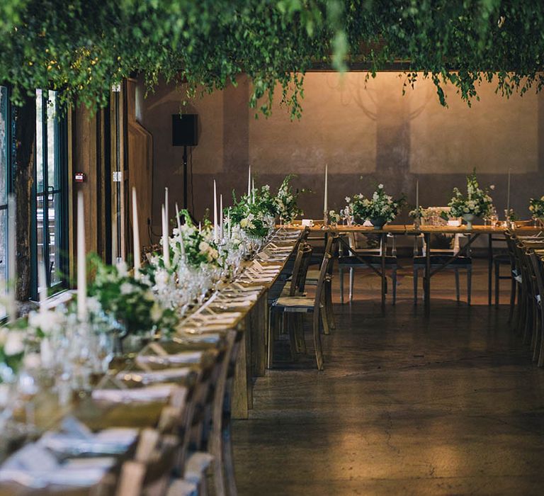 Wedding venue set up with white flowers, candles and greenery