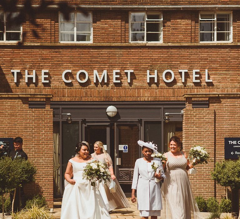 Bride walks with the bridal party to the wedding ceremony 