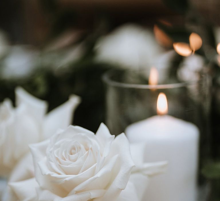 White rose and white pillar candle table decoration for classic wedding 