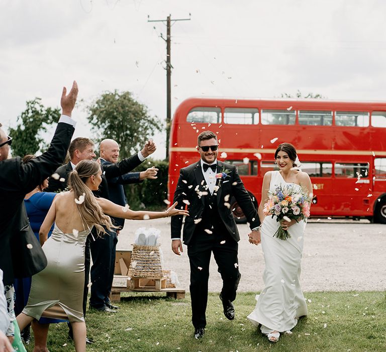 Bride and groom have white petal confetti exit from their wedding 