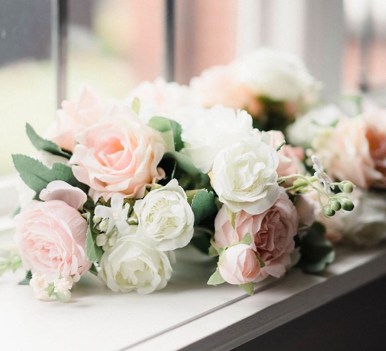 Pale pink and white rose bouquets for elegant wedding day 