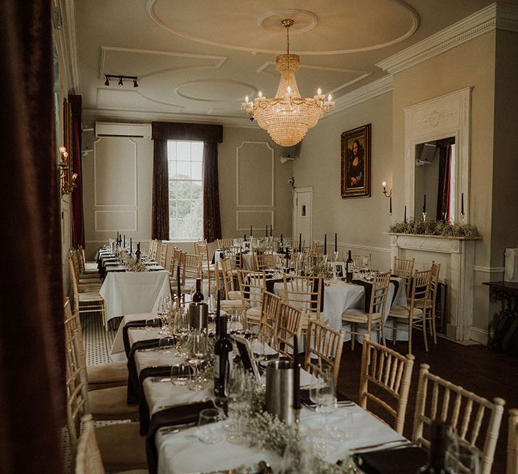 Gothic Belair House wedding complete with white tablecloths, black pillar candles and black napkins 