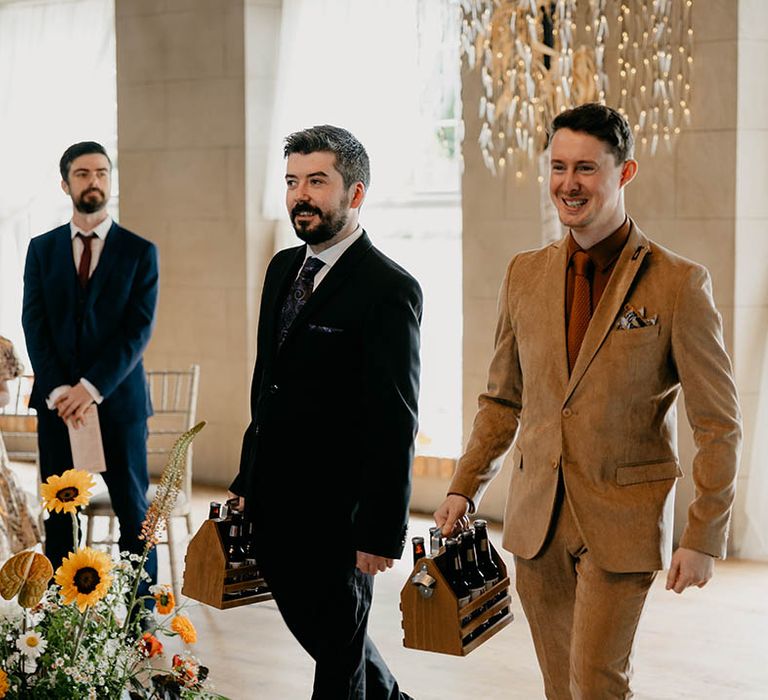 Beer men carrying personalised bottles of beer for the fun wedding at Gracehall