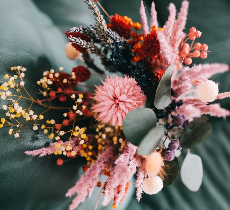 Brightly coloured dried floral bridal bouquet with pink pampas grass