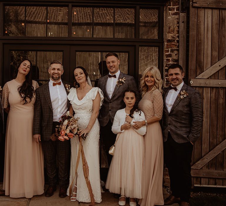 Bride and groom with the groomsmen, bridesmaids and flower girl 