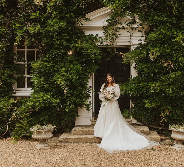 Bride in a Phillipa Lepley wedding dress with a sheer balloon sleeve overlay for Sprivers Mansion wedding 