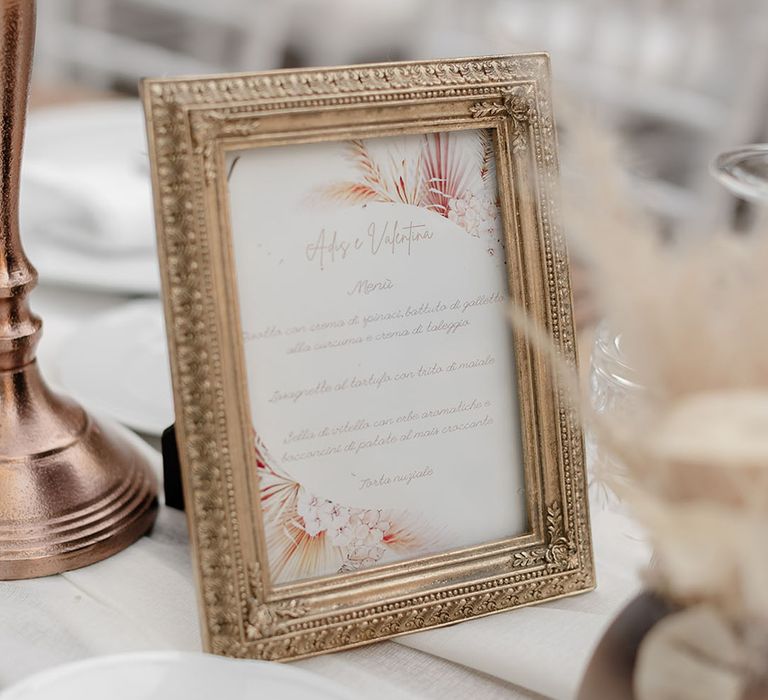 Gold antique frame surrounded wedding stationery with pastel toned illustrations 