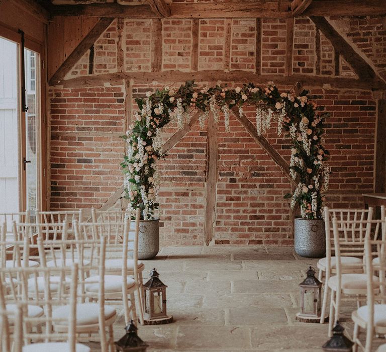 Pink and white flower arch altar decoration for rustic luxe wedding with metal lantern aisle decoration 