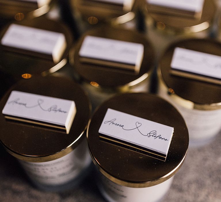 Personalised lids of the candle wedding favours the couple hands out to guests 