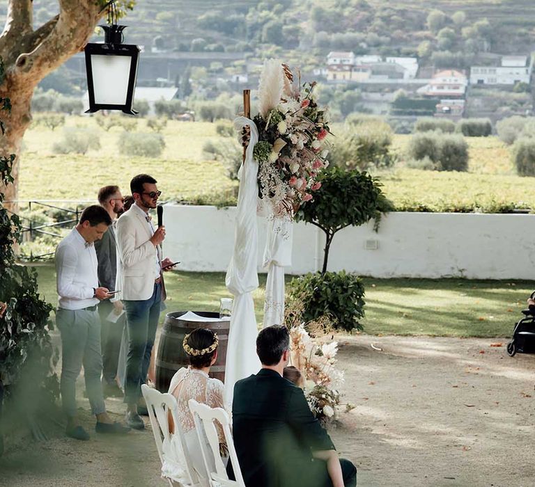 outdoor wedding ceremony officiated by the bride and grooms best friends 