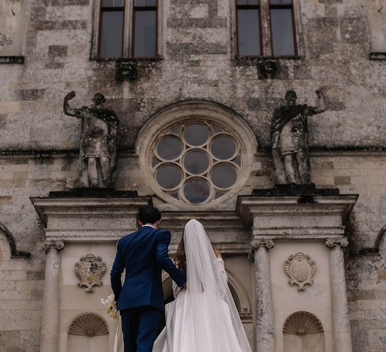 Traditional and luxe spring wedding with the bride and groom walking around their wedding venue together 