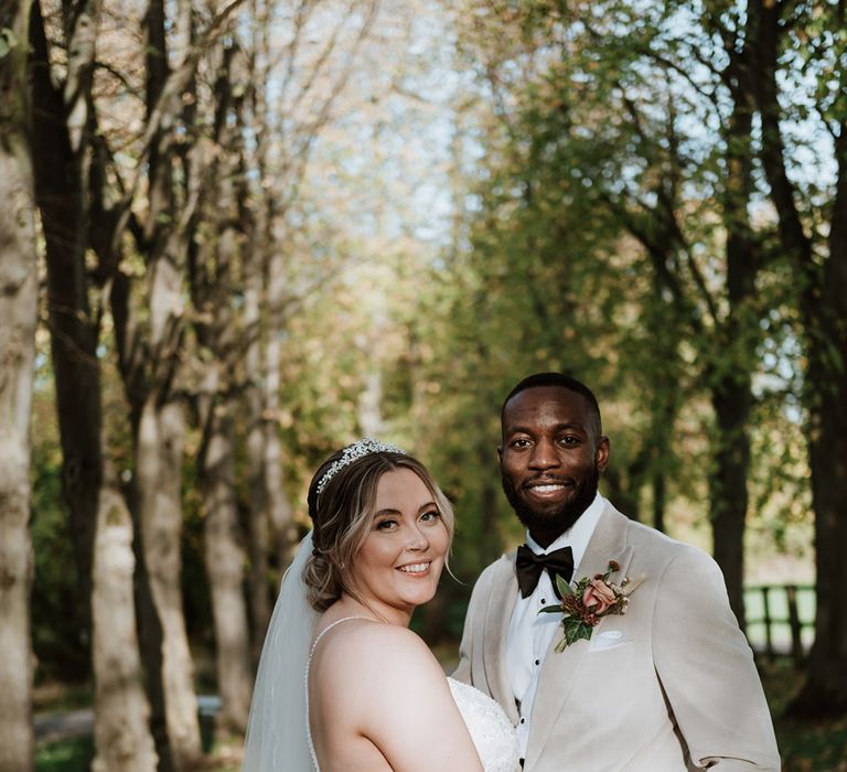 Romantic Colville Hall wedding in Essex with the bride in a floral lace beaded wedding dress and groom in a velvet suit 