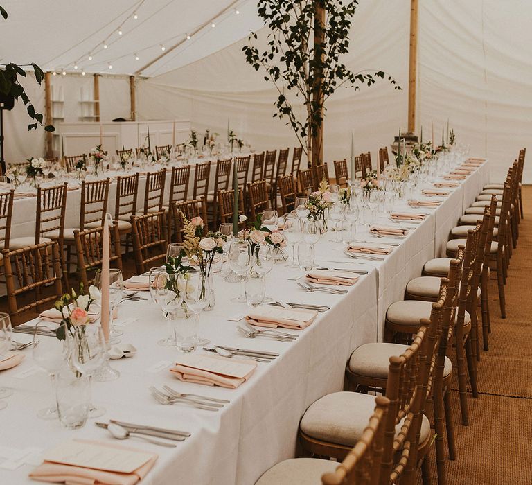 Marquee wedding breakfast with pale pink and white decorations 