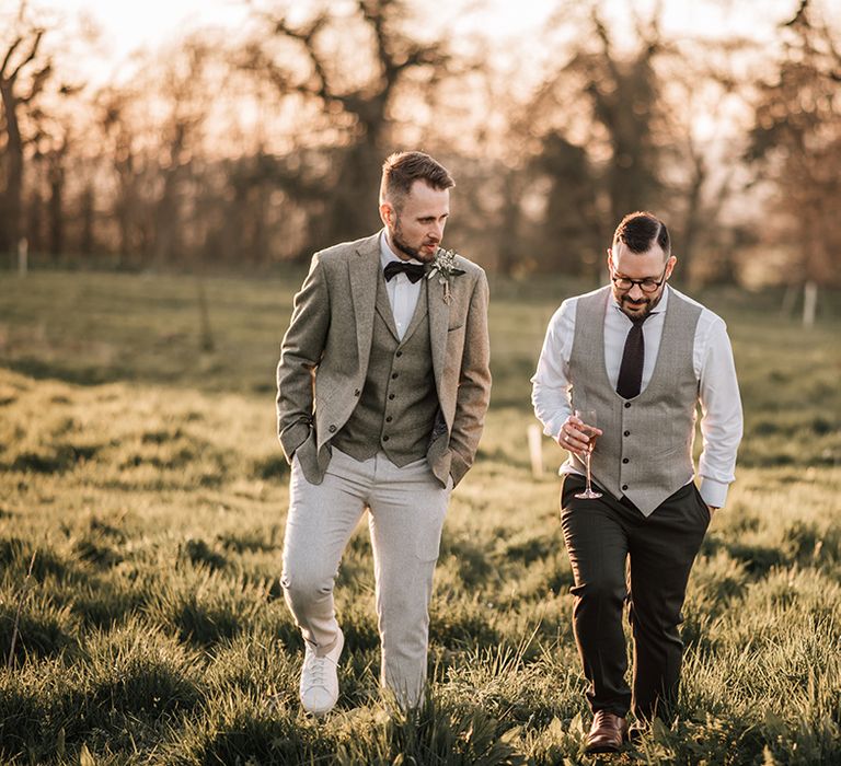 The two grooms stroll around Elmore Court wedding venue 