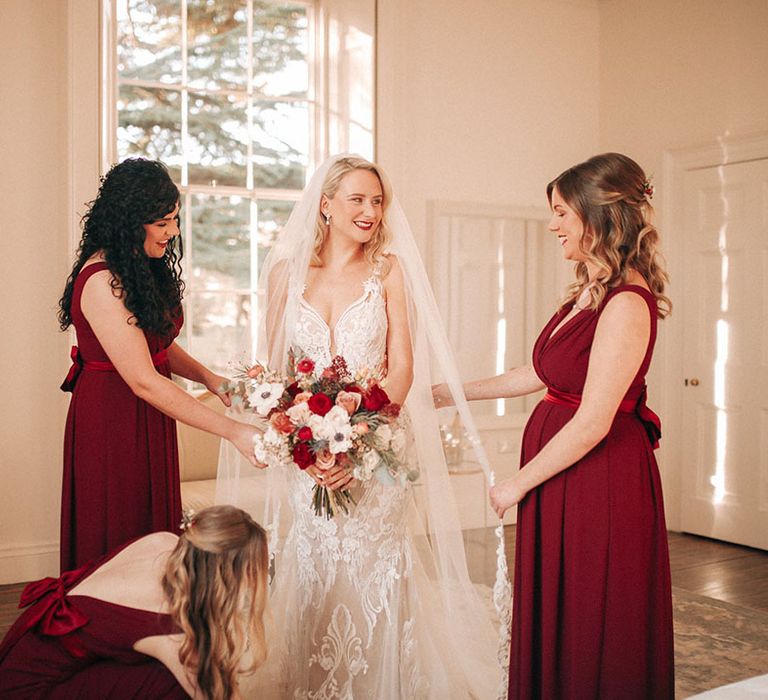 Bridal party wearing red bridesmaid dresses for winter wedding in December 