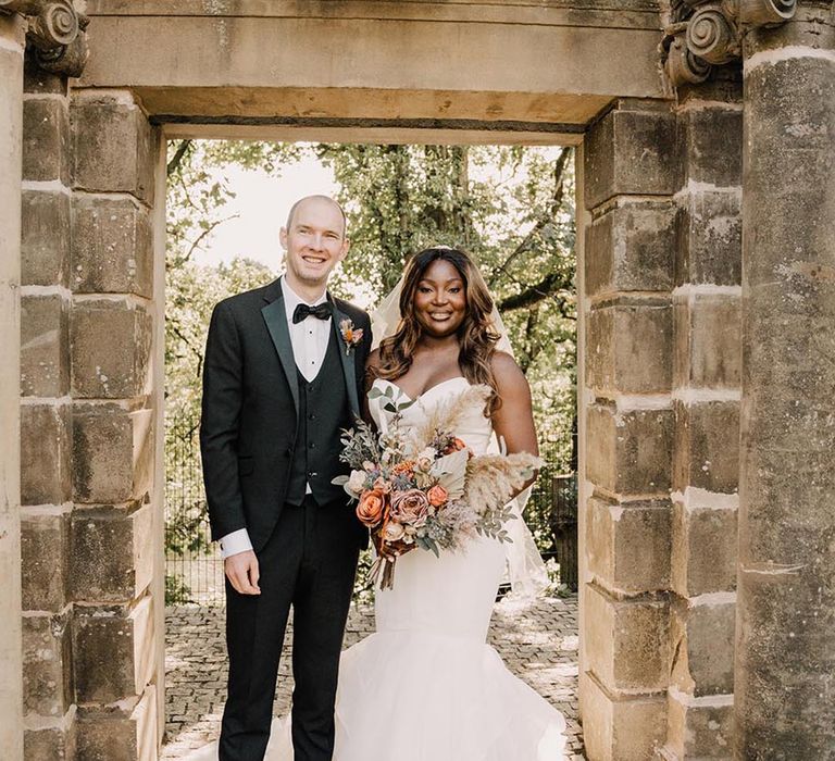 The Loft hotel wedding venue in Northern Ireland with groom in black tux and bride in sweetheart mermaid wedding dresses 