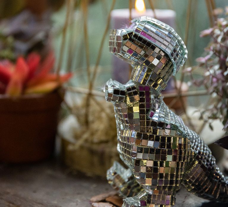 Mirrorball dinosaur decoration at eclectic wedding 