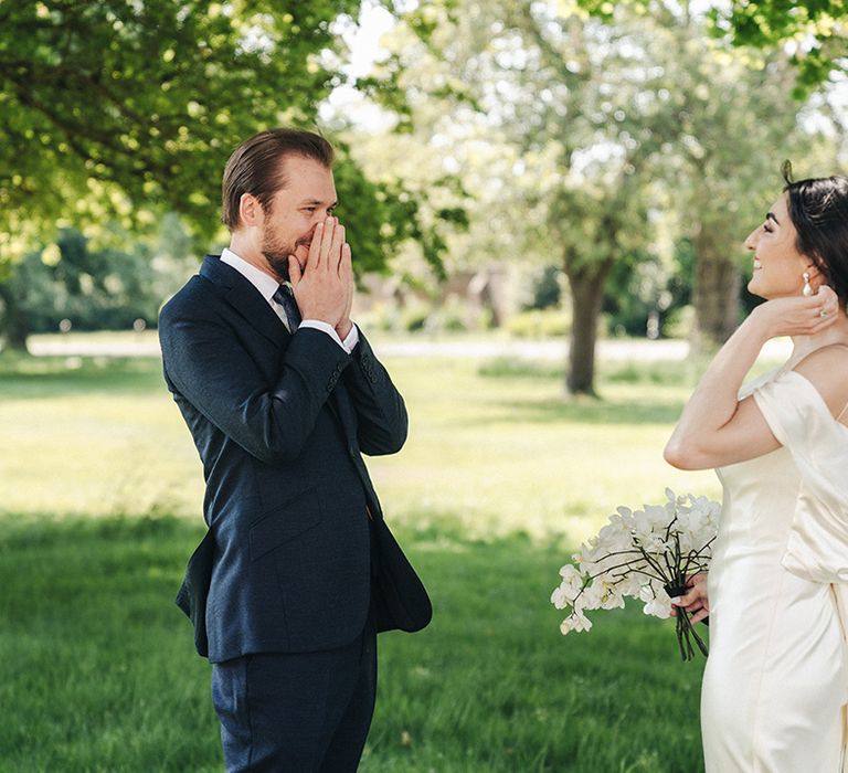 First look moment outside for the bride and groom as they see each other for the first time 