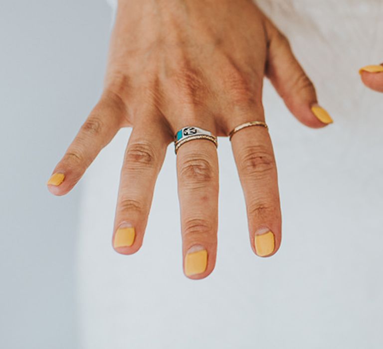 Colourful wedding nail idea with short nails painted in vibrant yellow 