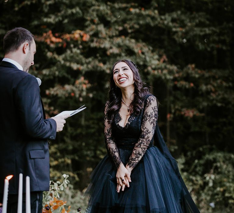 Brides smiles at the groom during their wedding vows at outdoor wedding ceremony in New York 