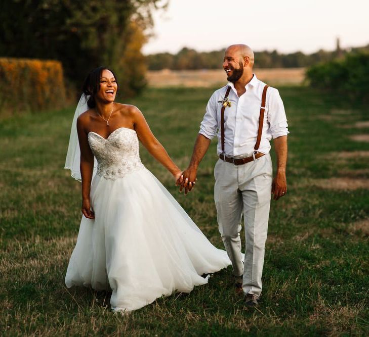 Bride and groom couples shot, walking through a vineyard