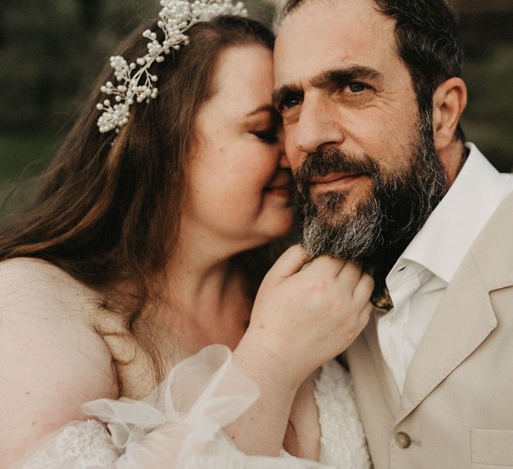 Bride leans into Groom's face in Tuscany olive grove