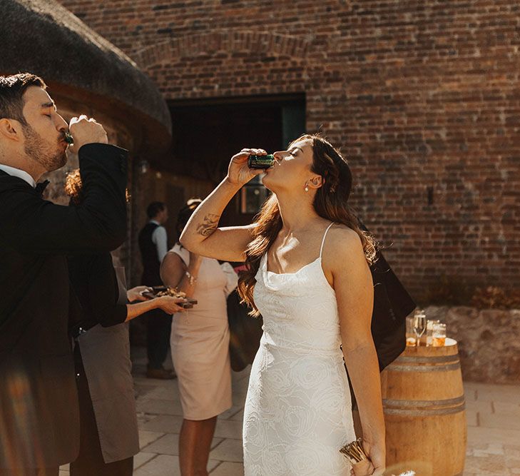 Bride and groom drink a shot at wedding