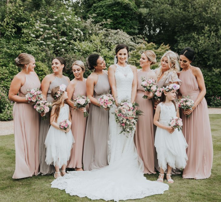 Bride in Christina Wu dress with bridesmaids in blush and lilac dresses