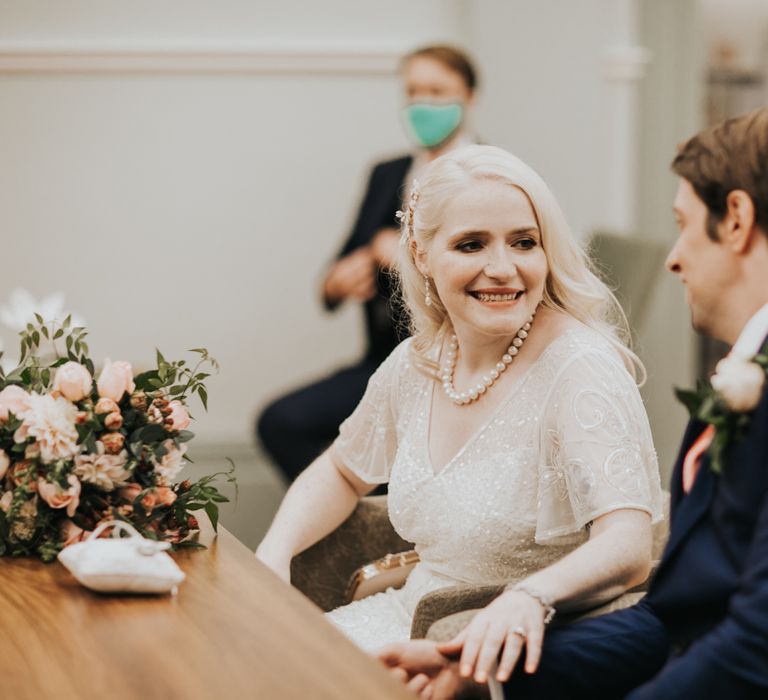 Bride & groom in registry office on wedding day 