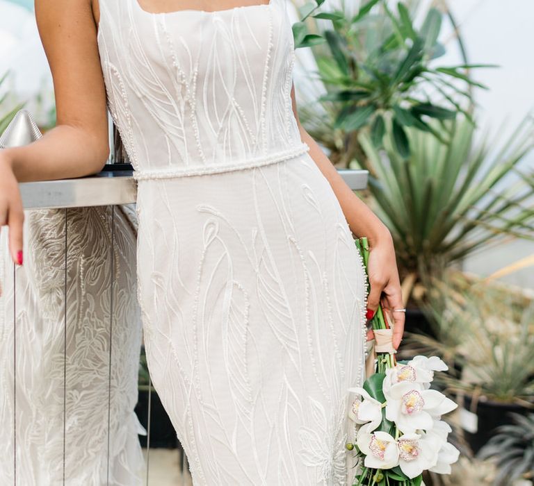 Bride in white Forrest by Rachel Rose Bridal dress holding jungle themed bouquet at Urban Jungle Suffolk