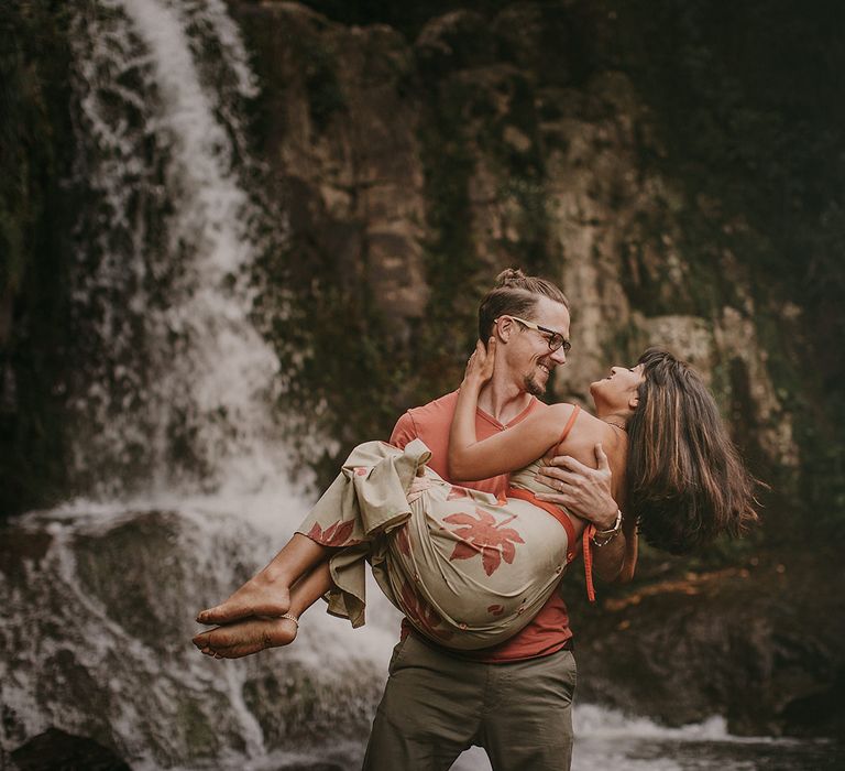 The bride and groom explored waterfalls before their New Zealand elopement ceremony