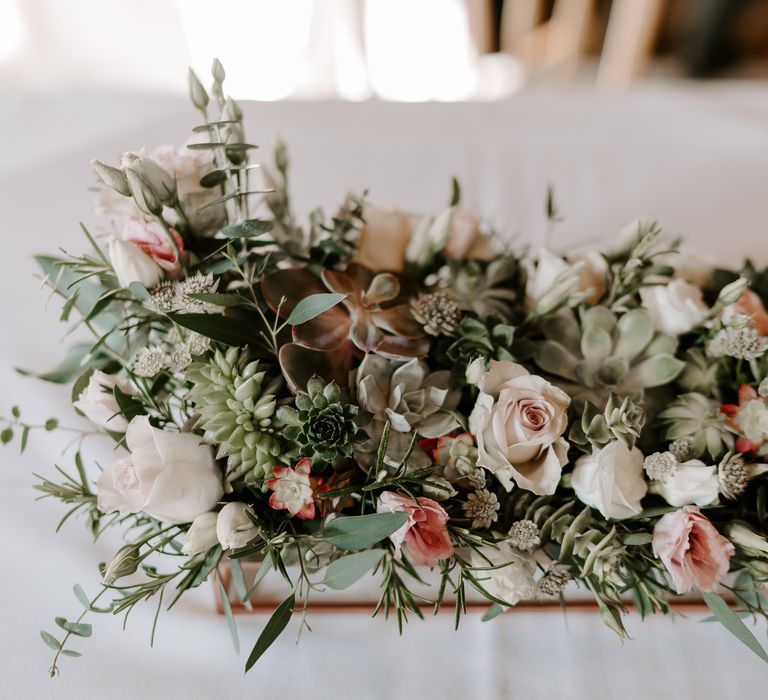 Pink and green wedding flower arrangement with roses and succulents 