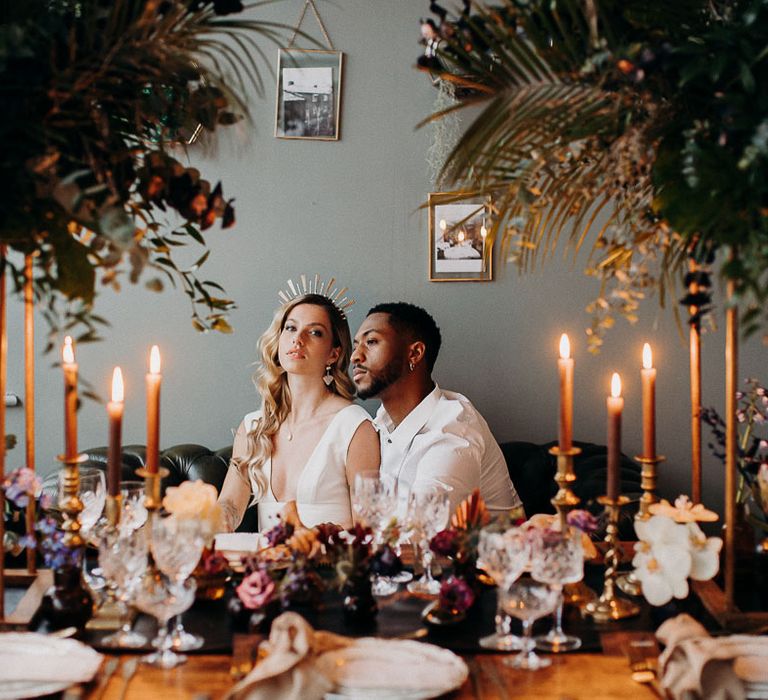 moody dark wedding flowers centrepieces and candles styling the intimate reception table 