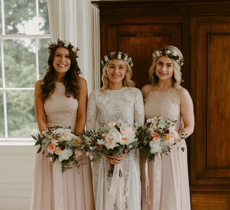 Bride in Grace Loves Lace Wedding Dress, single tier cathedral length veil and flower crown at Drenagh Estate wedding with bridesmaids in pink silk dresses holding pink and white rose bouquets