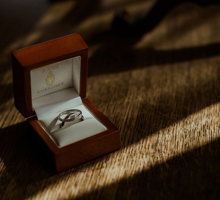 Silver engagement rings within wooden box