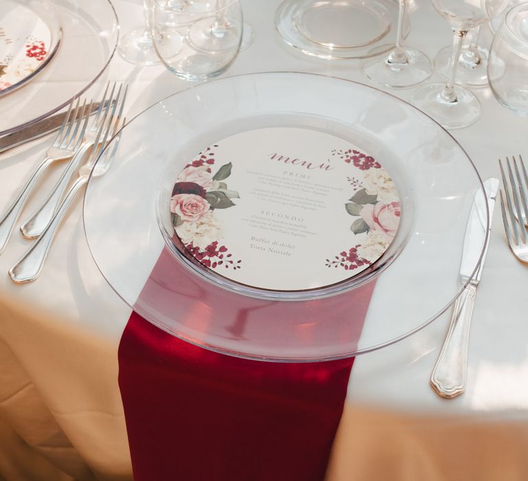 Minimal white table decor with burgundy napkin detail