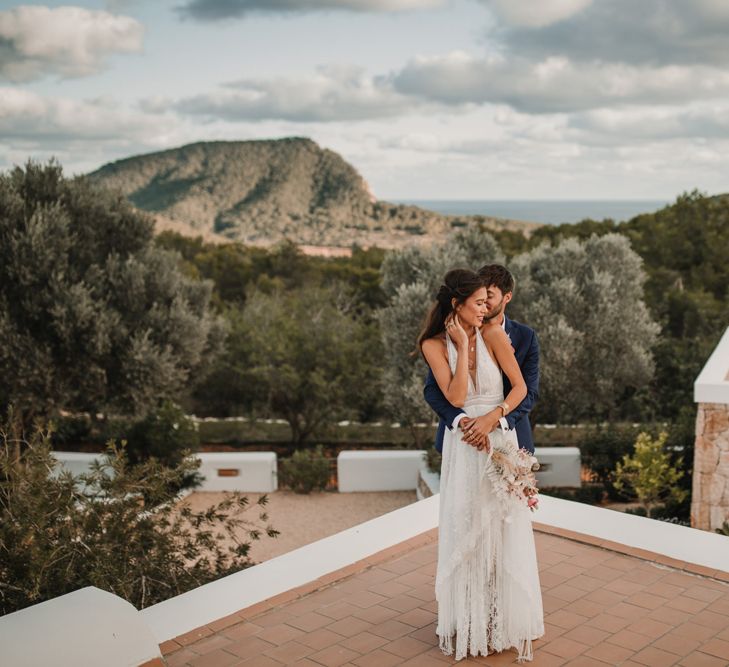 Bride and groom portrait with bride in a Marylise Bridal gown with Ibiza scenery in the background