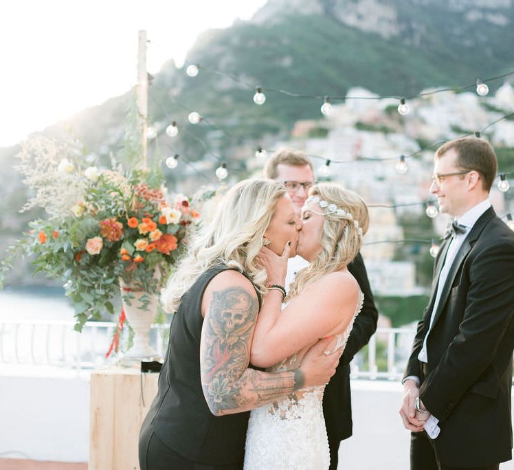 The brides kiss at the end of their wedding ceremony at Hotel Marincanto